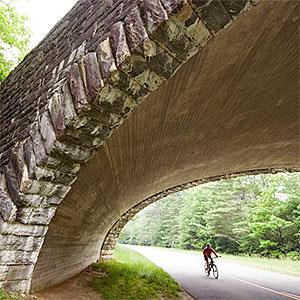 Bicyclist under bridge